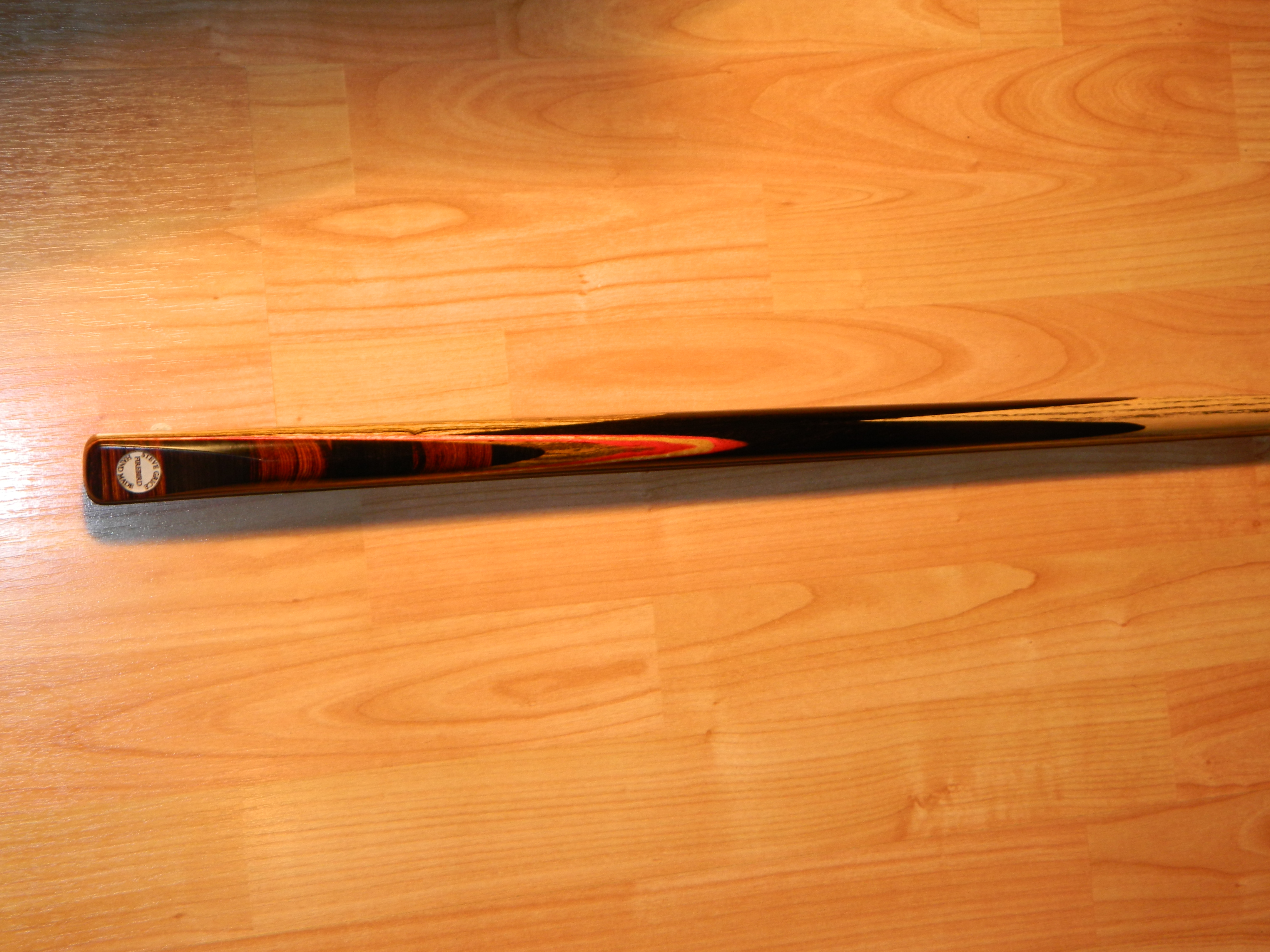 Steve Grice Cues Firebird an exceptionally long  hand spliced ebony butt  for enhanced playing characteristics tulip spliced thereafter with ahumbug front wedge.